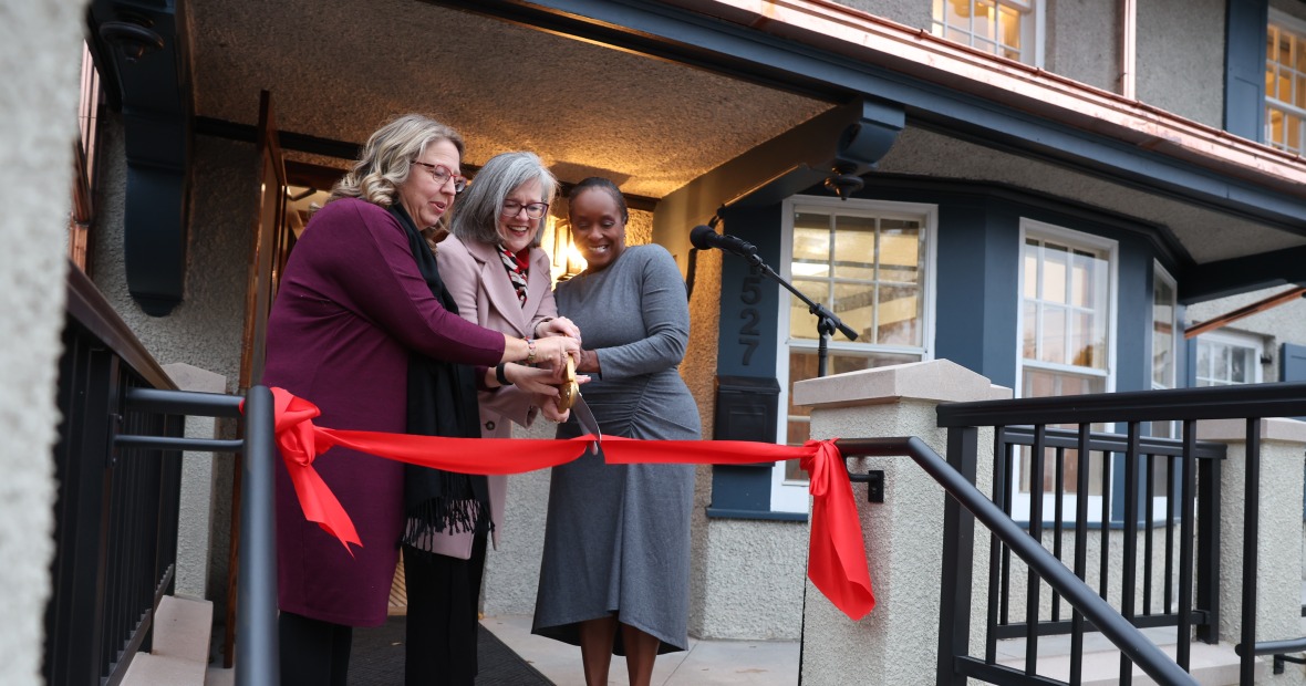 Rachel Bly ’93, left, President Anne F. Harris, and Bernadine Douglas cut the ribbon during the Hannah Alumni House dedication Thursday.