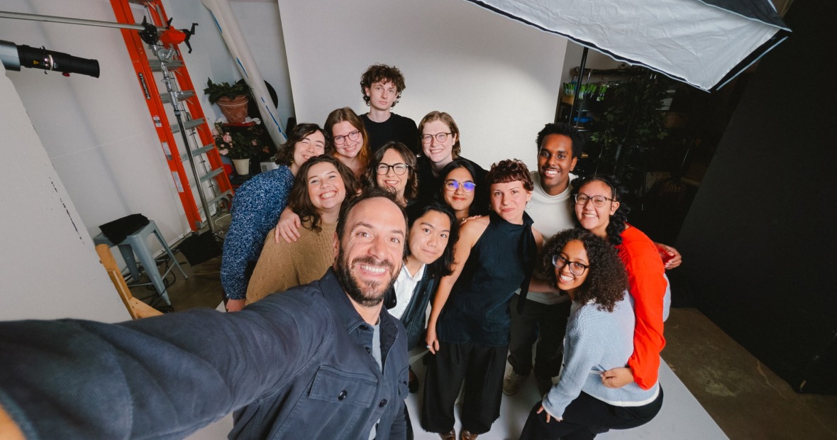 A group of Grinnell students poses for a selfie with a professional photographer