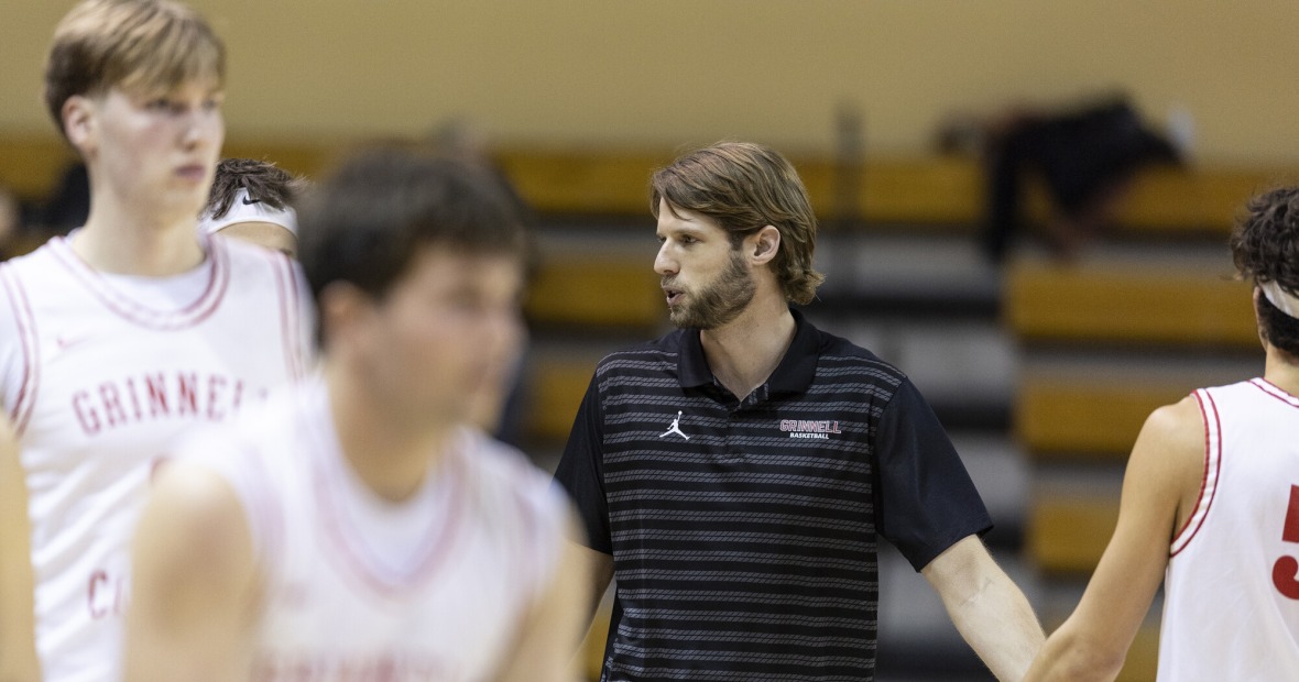 Jeff Smith giving players high fives on court