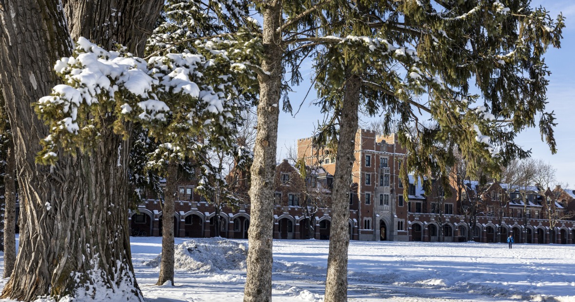 snow on ground and gates building in background