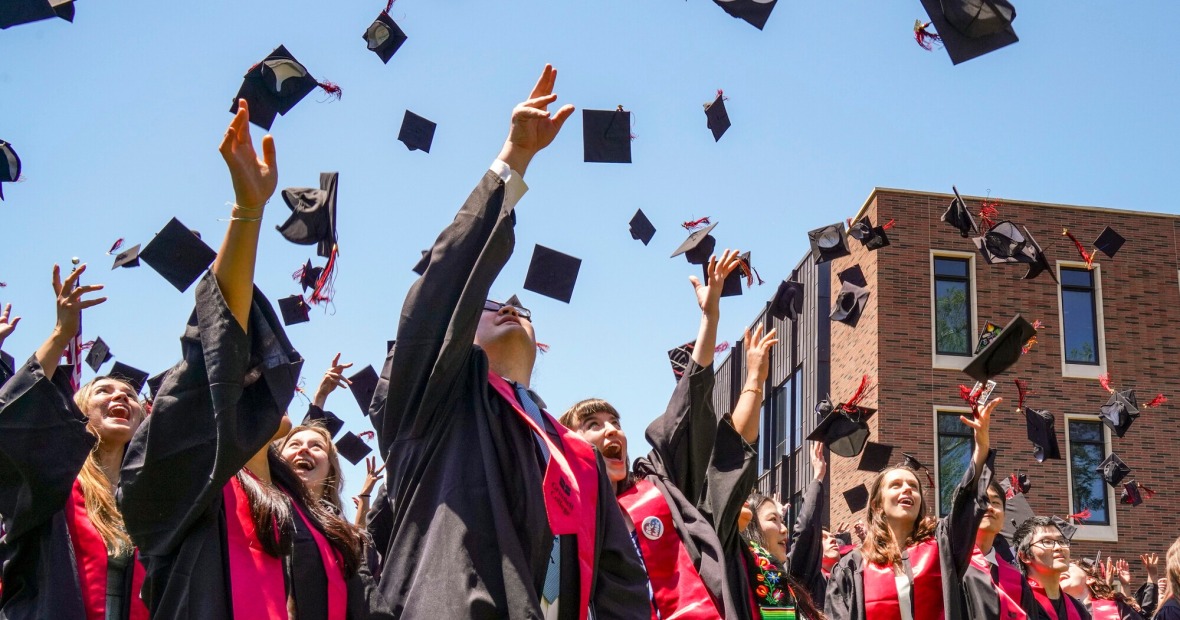 graduates throwing hats in the air 