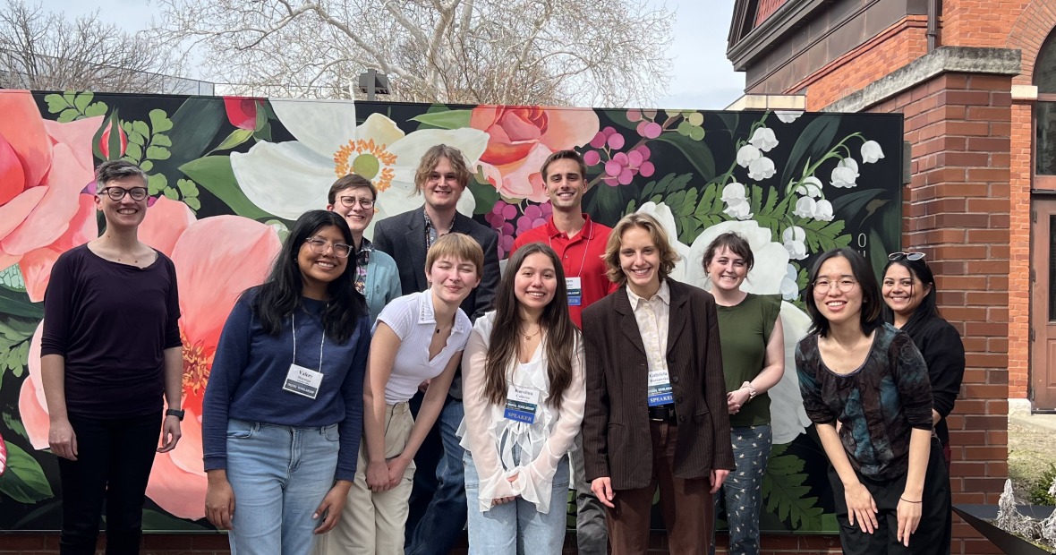 People standing in front of flower background 
