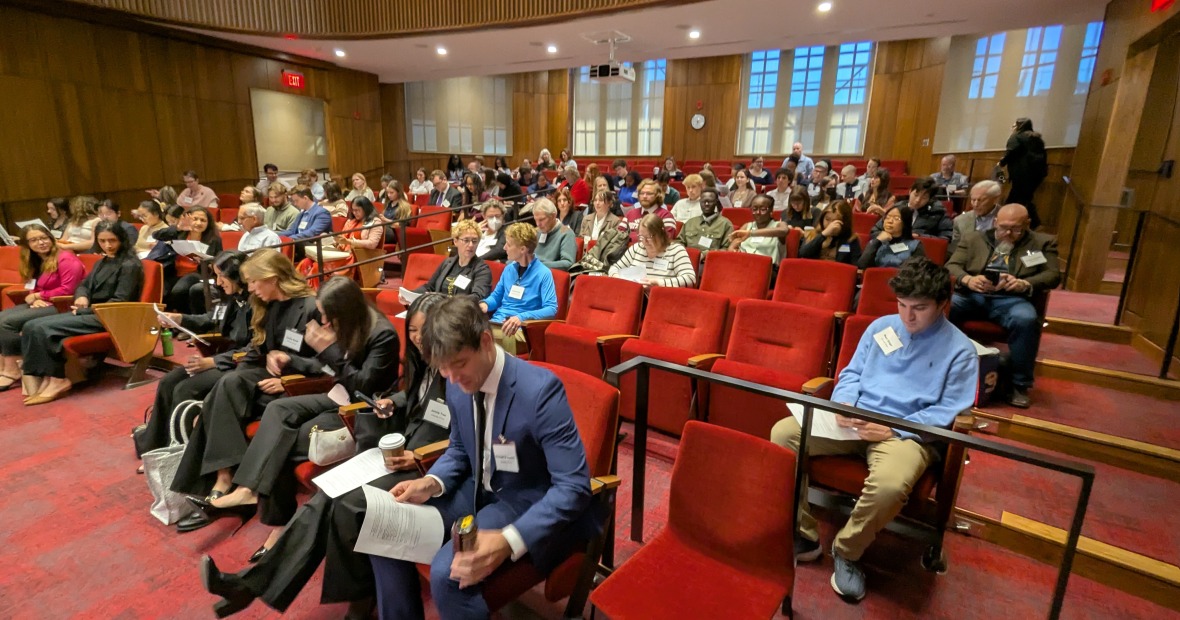 Participants in the Iowa Human Rights Research Conference are seated in an auditorium