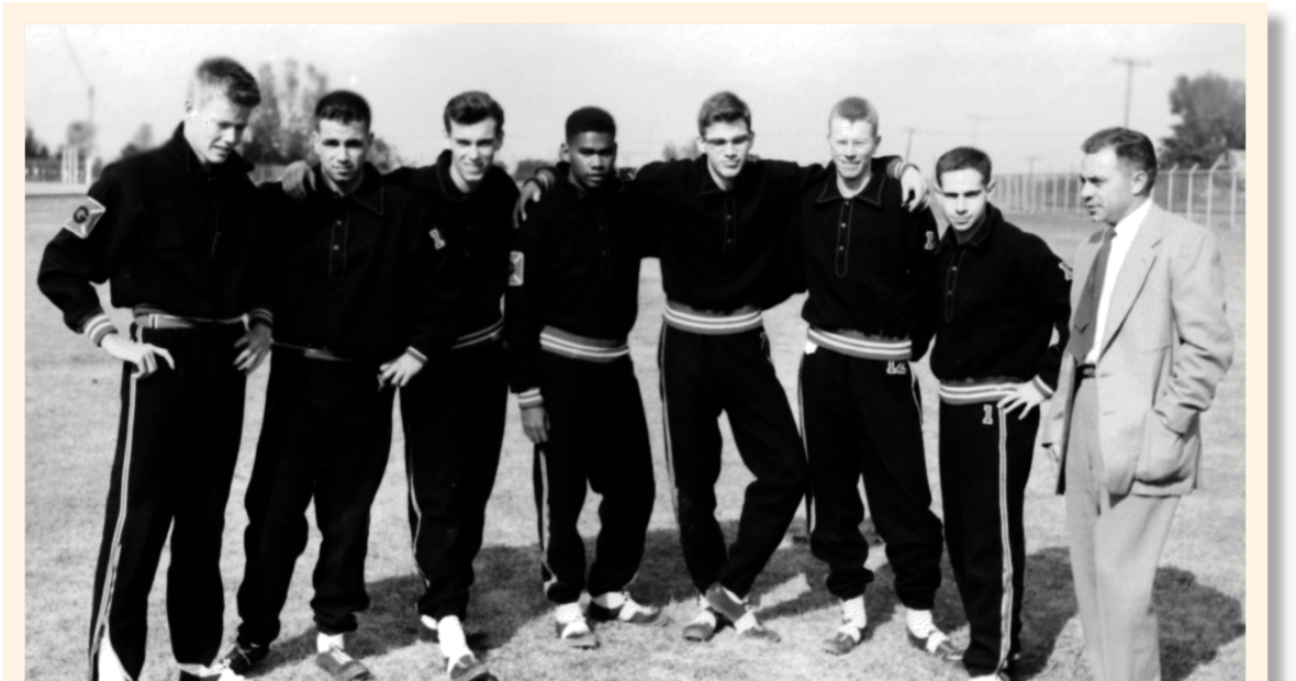 George Drake with his cross-country team and coach. The runners wear their track suits