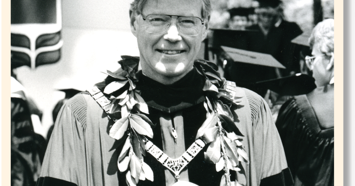George Drake wears his robes and hat with laurel leaves and the president's chain of office and medallion
