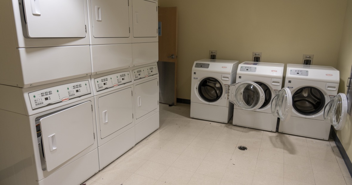A laundry room showing washers and dryers.