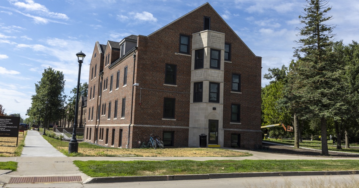 Loose Hall is a three-story brick building with a gabled roof.