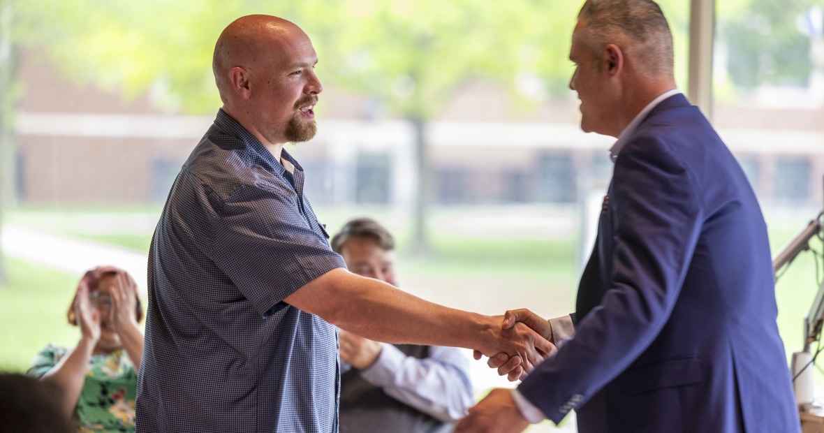 Matt Kriegel shaking hands with JC Lopez