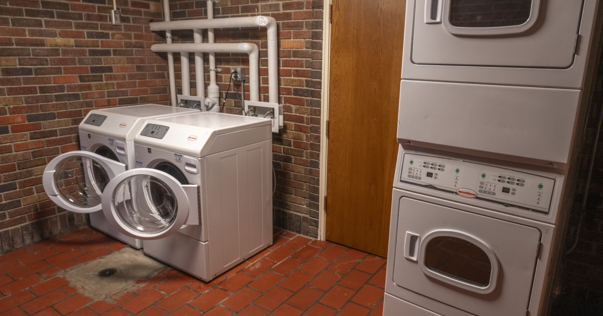 A laundry room showing washers and dryers.