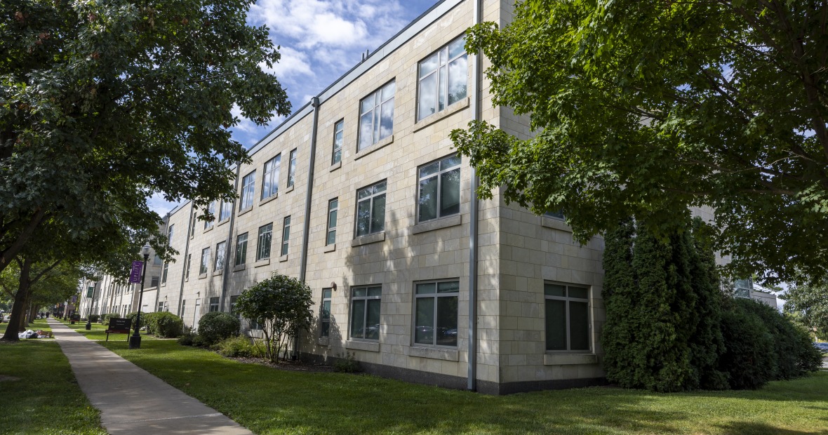 Rathje Hall is a four-story concreate building with large glass windows.