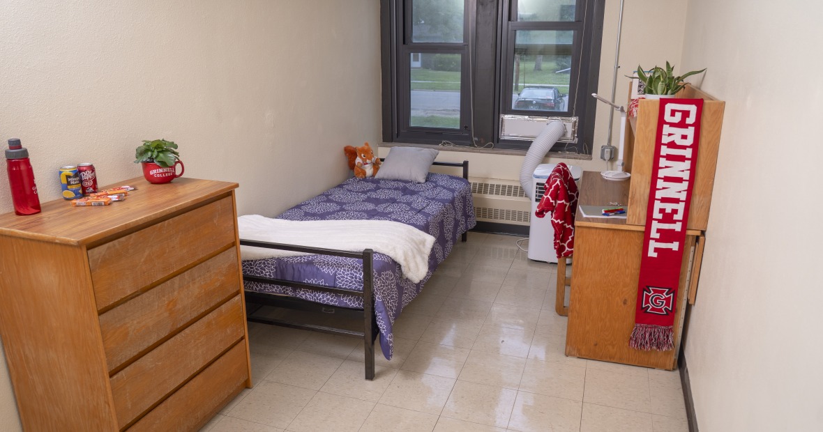 Single bedroom with a window. It has bed, desk, and dresser.
