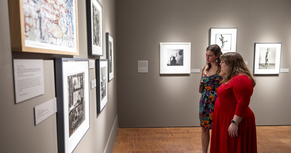 two students looking at art 