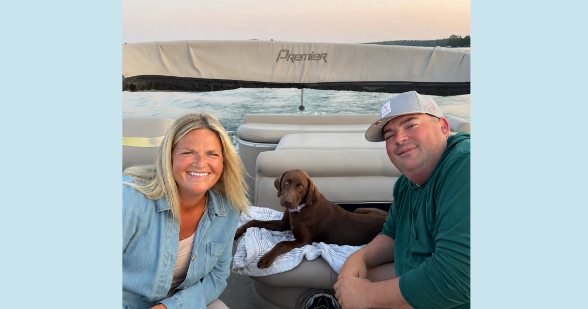 two people and chocolate lab on a boat
