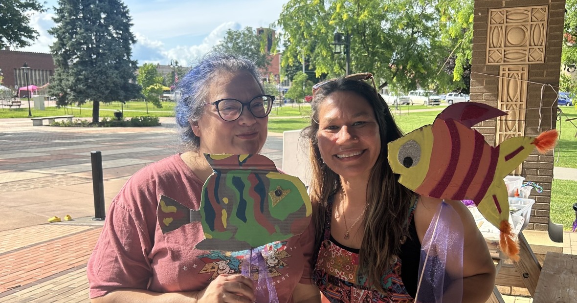two women holding puppets 