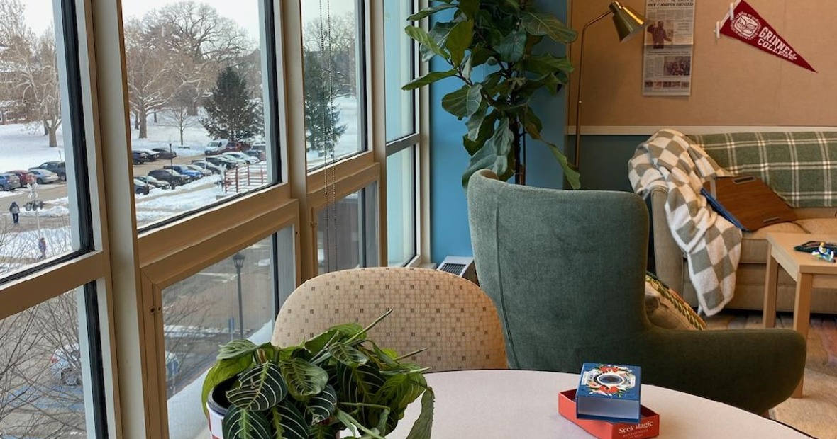 a table with puzzle pieces next to windows overlooking East campus