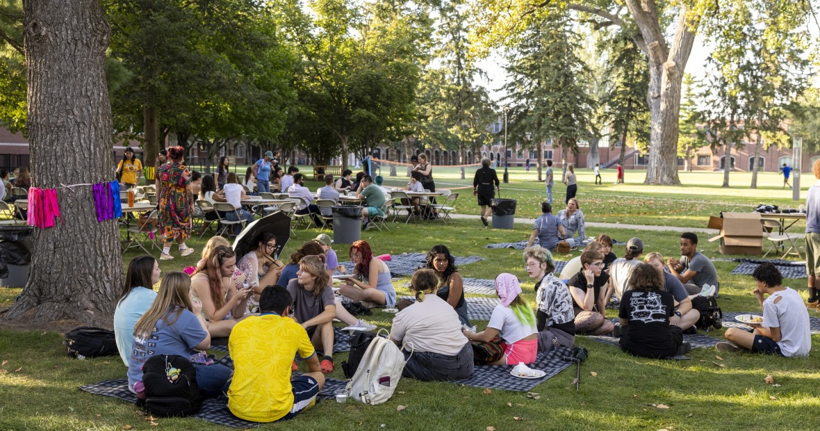 Students enjoying a picnic at the Stonewall Resource Center (SRC) welcome event.