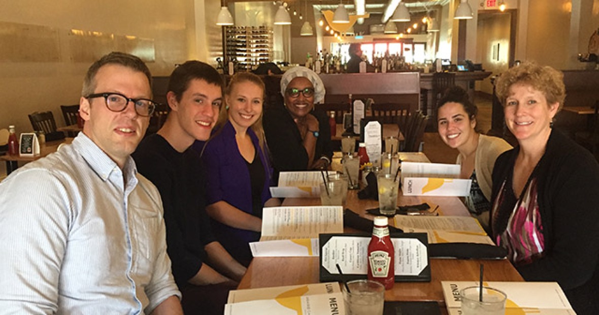 Mixed group of faculty and students sitting in a restaurant
