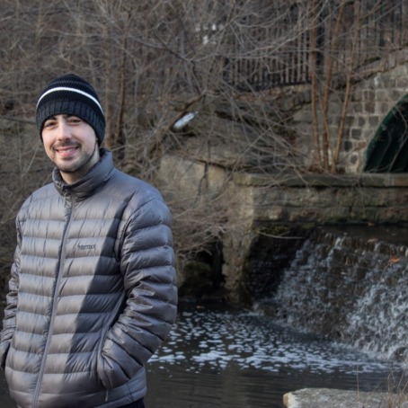 Nick Hunter in warm clothing near a spillway