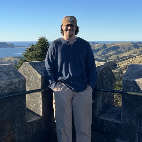 Haden Horstman smiles for a photo on a river overlook