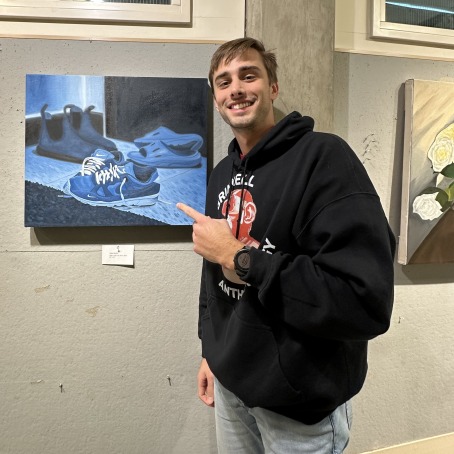 a man points to artwork