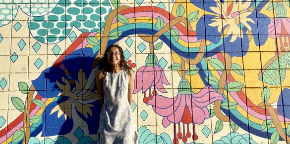 Jivyaa Vaidya standing in front of a colorful mural