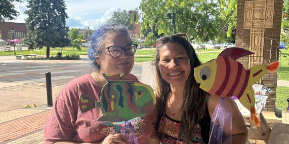 two women holding puppets 