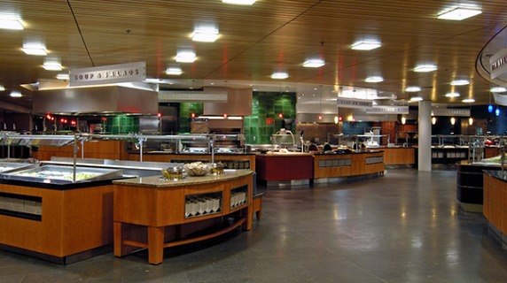 Empty Marketplace dining hall showing several stations and a fully stocked fruit stand