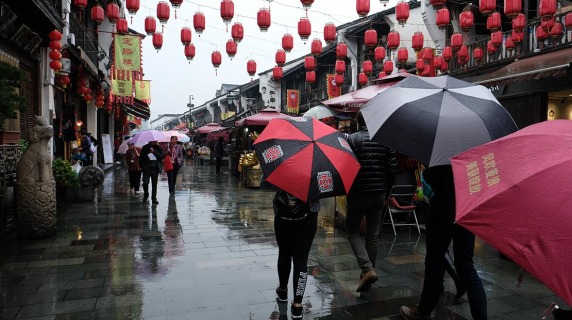 Scarlet and Black umbrella sporting the Honor G mixes amongst the rest of the umbrellas on a rainy day. 