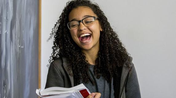 student laughs at blackboard
