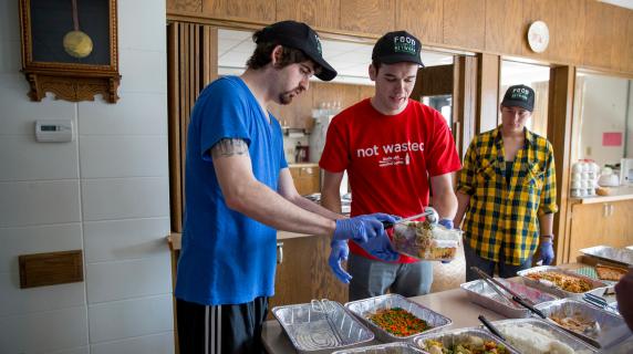 Food Recovery Network volunteers serve to local community meal