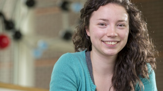Photo of Grinnell student at table in Noyce Science Center.
