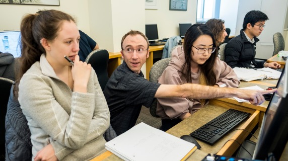 Students working with a professor