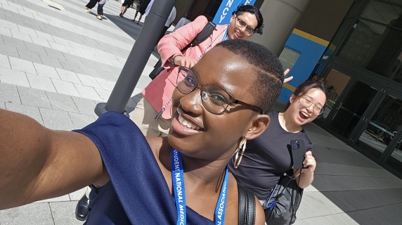 Essi takes a selfie in front of the medical conference building.