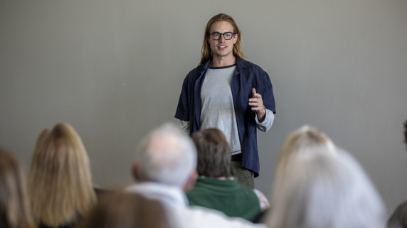 a man speaks in front of an audience