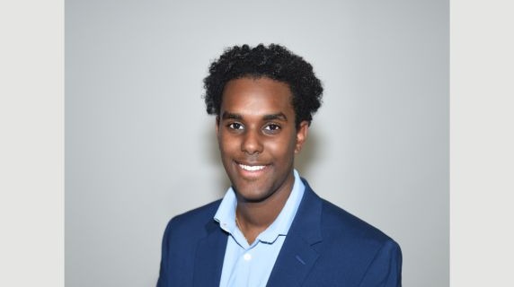 Noah Biniam smiles for a headshot