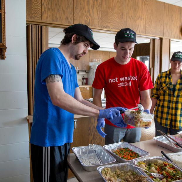 Food Recovery Network volunteers serve to local community meal