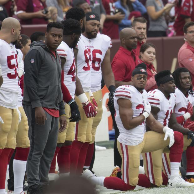San Francisco 49ers football players kneel during the national anthem