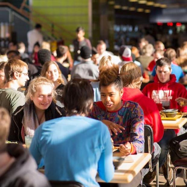 Students eating and talking in the dining hall