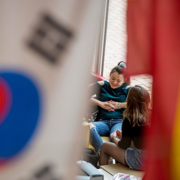 Students visible between two flags