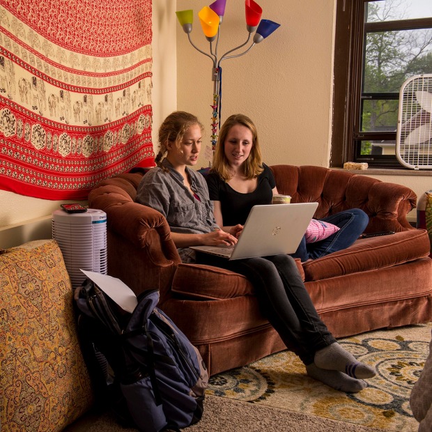 two students sit in dorm room