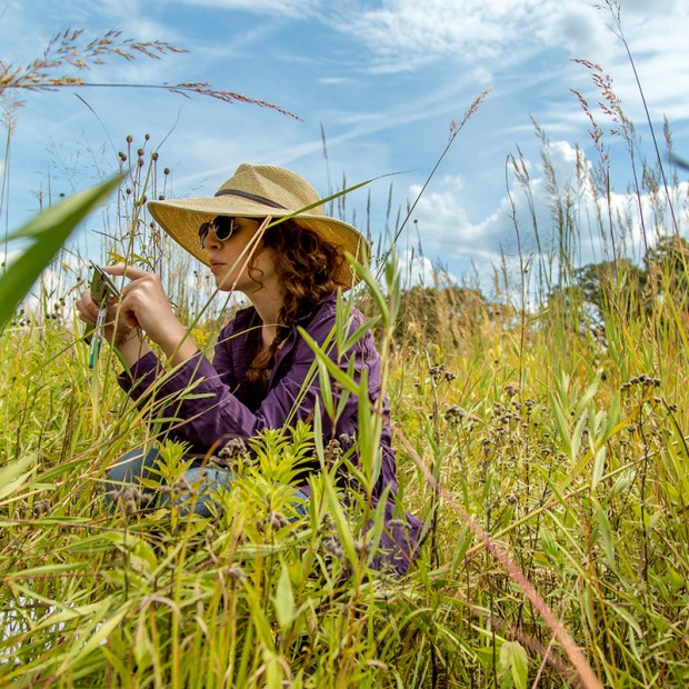 Student in sun hat takes photos of prairie life at CERA