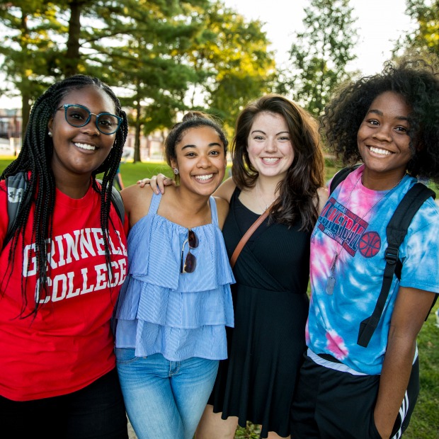 Four women stand together at NSO campus picnic