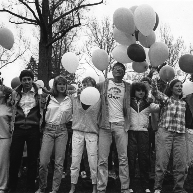 Students stand with their arms around each other before releasing their balloons as a peace demonstration protesting bombing in Libya, 1986. 
