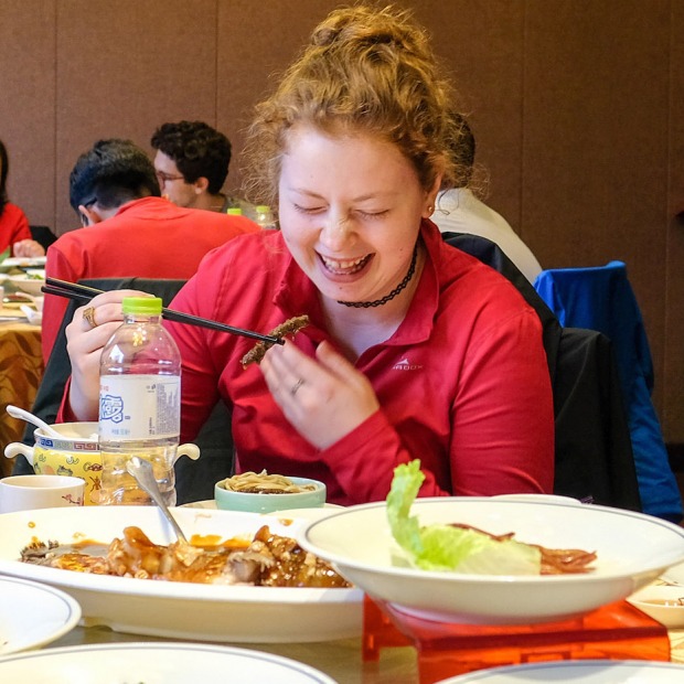 A student using chopsticks at a restaurant in China