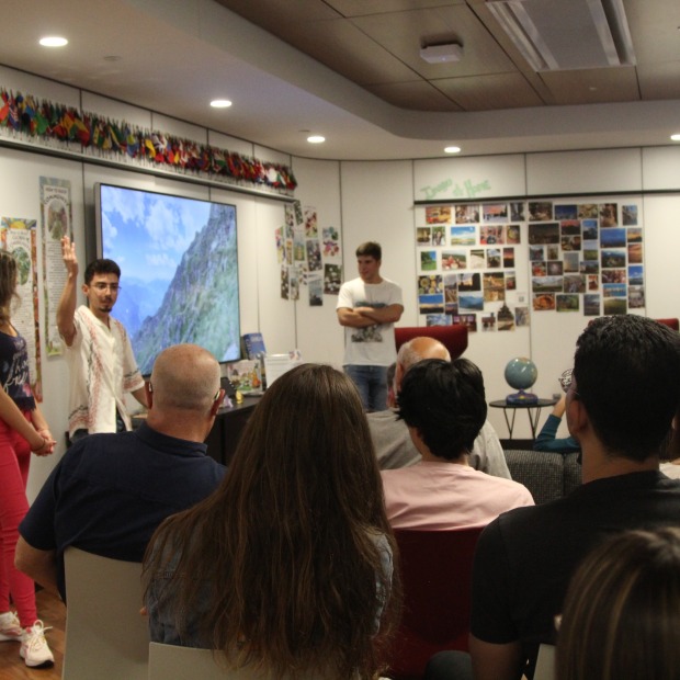 Students present in a roomful of people.