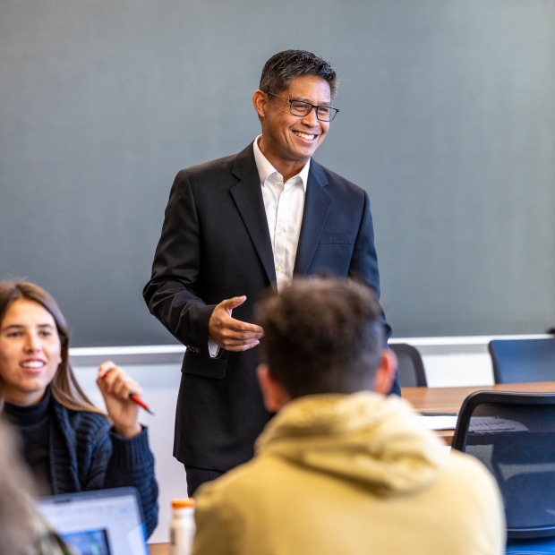 a male professor teaches a college class