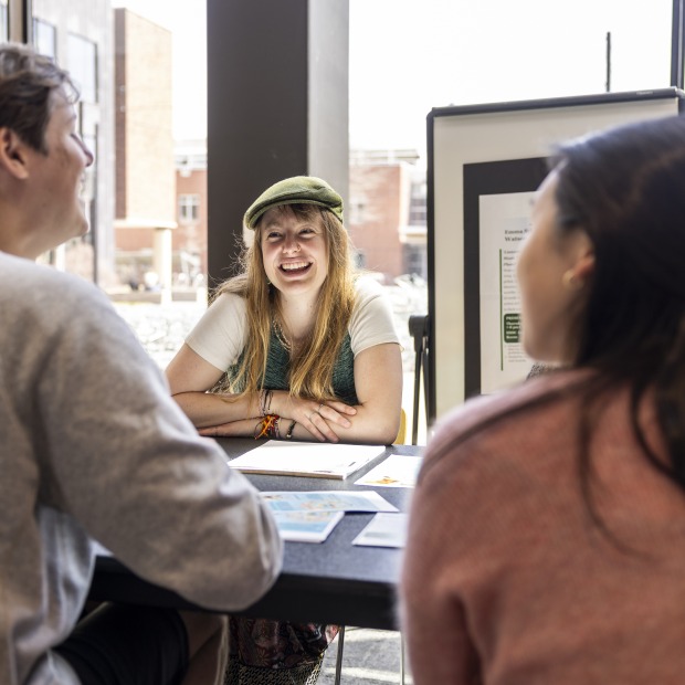 students speak across a table