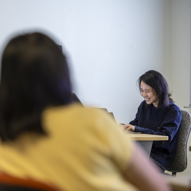 students talk in a classroom