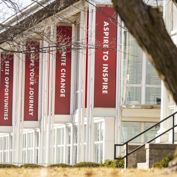 Exterior of the Center for Careers, Life, and Service building with red banners flying