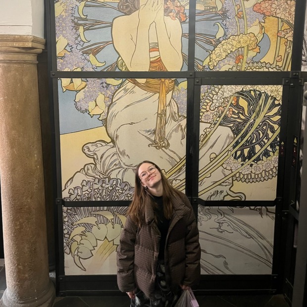 Aubrie Connell posing in front of artwork